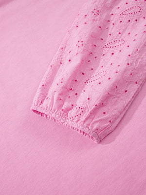 Pink cotton crew-neck sweatshirt with embroidered eyelet detail on the sleeve cuff.