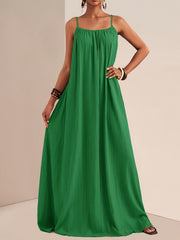 Green crinkled maxi dress with spaghetti straps and empire waist, perfect for maternity wear.