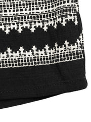 Black sleeveless top with white geometric print detail and solid hem
