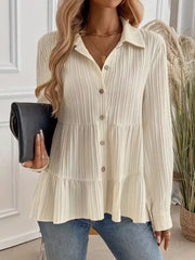Cream textured tiered button-down shirt with crinkled fabric and button details.