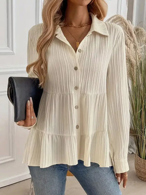 Cream textured tiered button-down shirt with crinkled fabric and button details.
