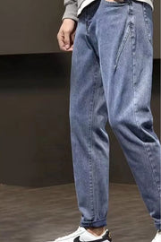 Relaxed fit plus size straight leg jeans in medium wash cotton, cuffed at the ankle.