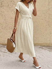 Beige cotton blend midi dress with V-neck, short sleeves, and twisted knot waist detail.