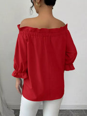 Red off the shoulder blouse with ruffled neckline and bow sleeve details.