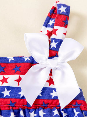 Star-spangled cotton dress with white bow detail and ruffled hem.