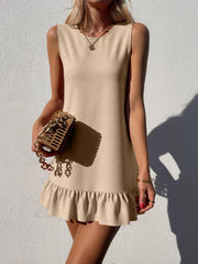 Backless mini dress in beige with ruffled hem and crew neck.