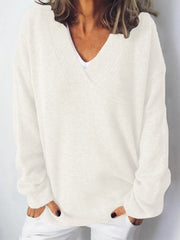 Relaxed ivory ribbed knit V-neck sweater with long sleeves.