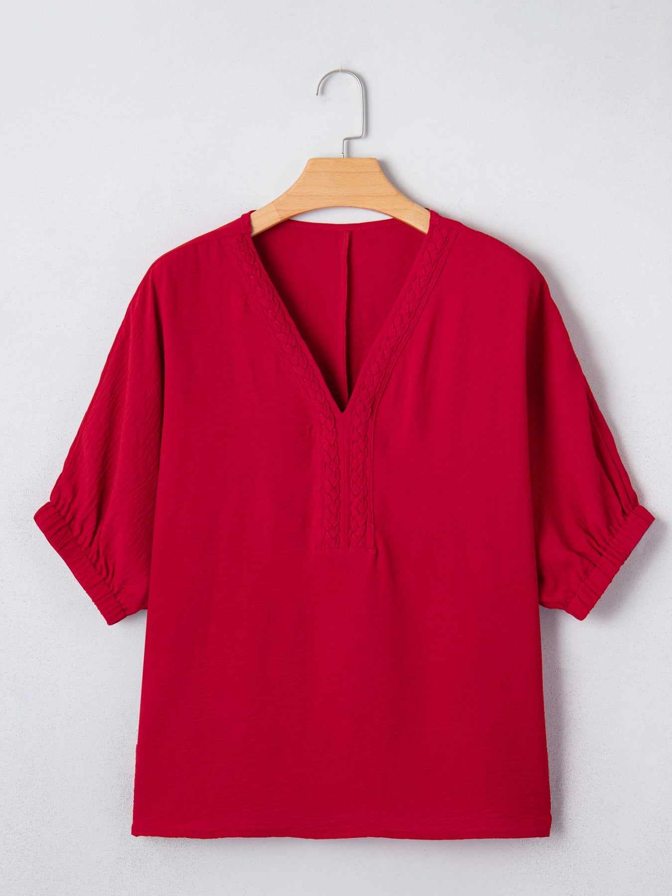 Red braided V-neck half sleeve blouse with textured fabric and elastic cuffs.