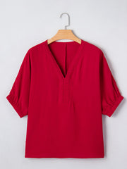 Red braided V-neck half sleeve blouse with textured fabric and elastic cuffs.
