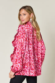 Hot Pink ruffle front blouse with abstract print and balloon sleeves.