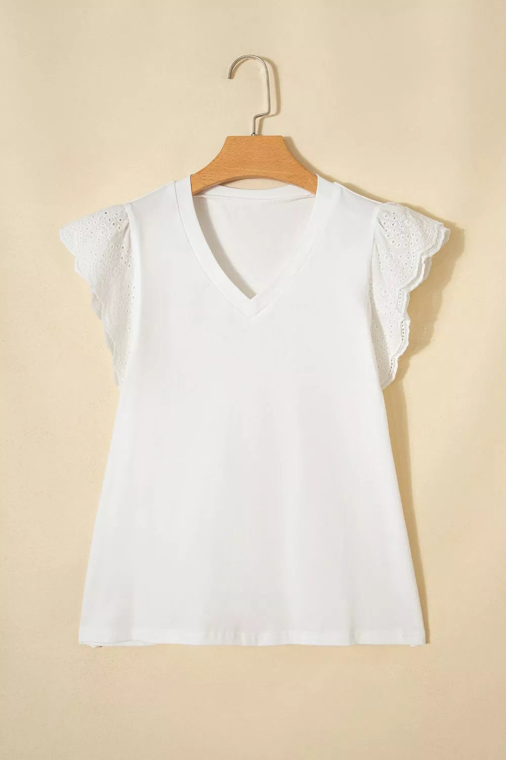 White cotton maternity t-shirt with V-neck and delicate eyelet flutter sleeves.