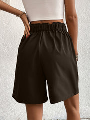 Pleated front bermuda shorts in chocolate with elastic waist and relaxed fit.