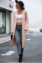 Longline knit cardigan in watermelon pink with pockets, acrylic material, open front.