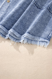Acid wash denim shirtdress in medium with raw hem detail and button closure.