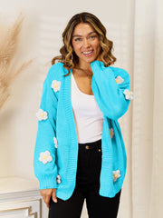 Light blue acrylic cardigan with balloon sleeves and 3D flower appliques