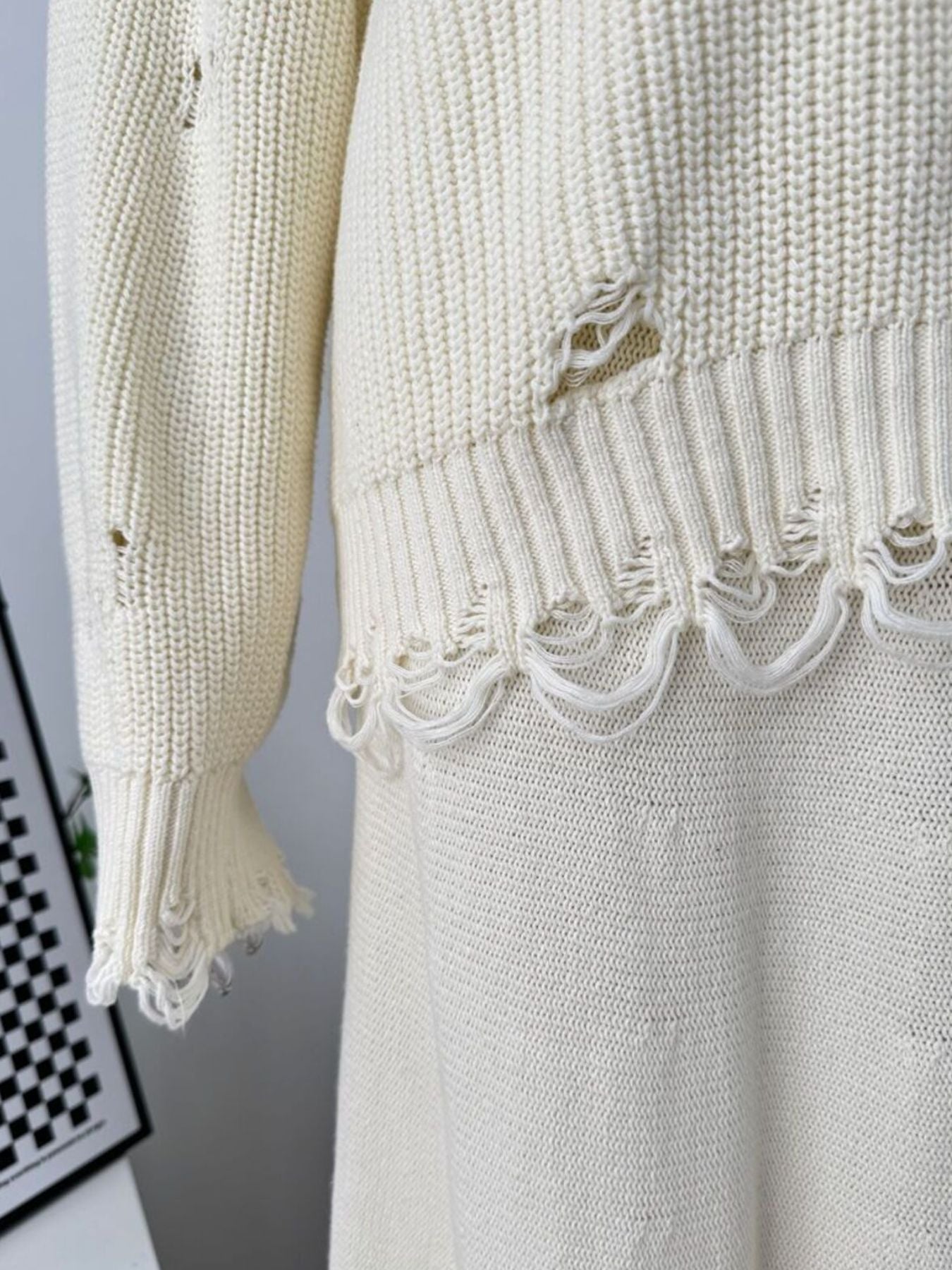 Off white distressed cotton sweater set with deconstructed hem and sleeve details.