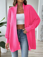 Ribbed knit cocoon cardigan in bright pink with an open front and long sleeves.