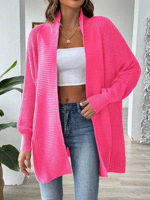 Ribbed knit cocoon cardigan in bright pink with an open front and long sleeves.