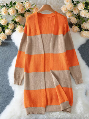 Long color block knit cardigan with orange and beige stripes, open front, ribbed texture.