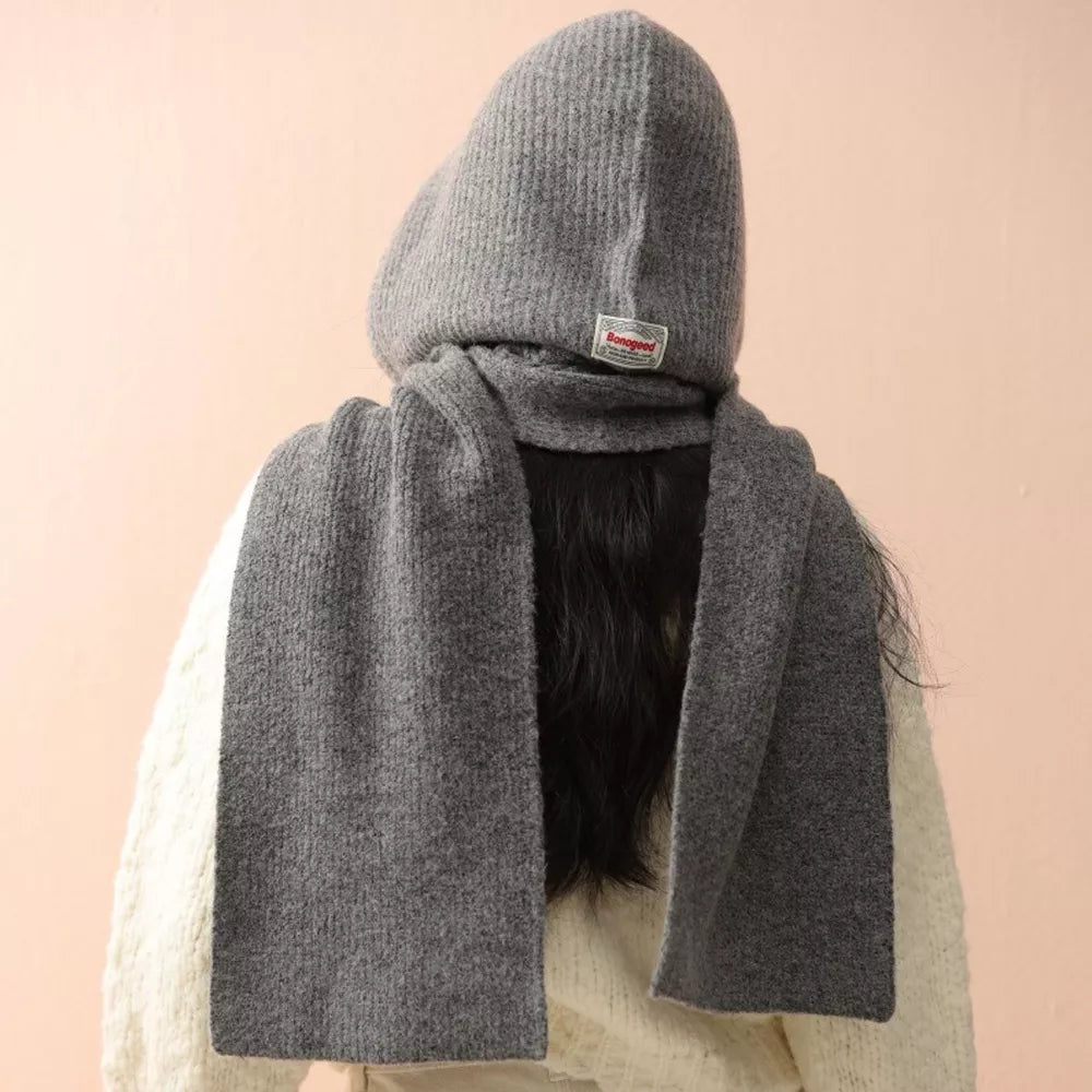 Gray knit hooded scarf with a tie detail and a small red tag.