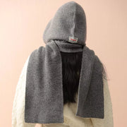 Gray knit hooded scarf with a tie detail and a small red tag.