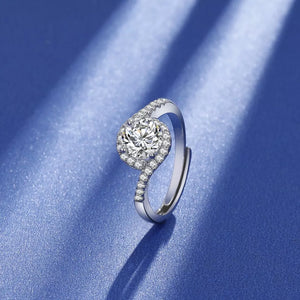 Dazzling Moissanite Halo Ring in Silver with a round center stone and pave band.