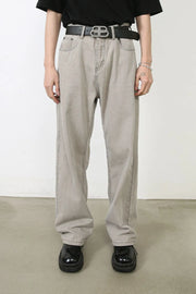 Gray wide-leg denim trousers with seam details and a relaxed fit.