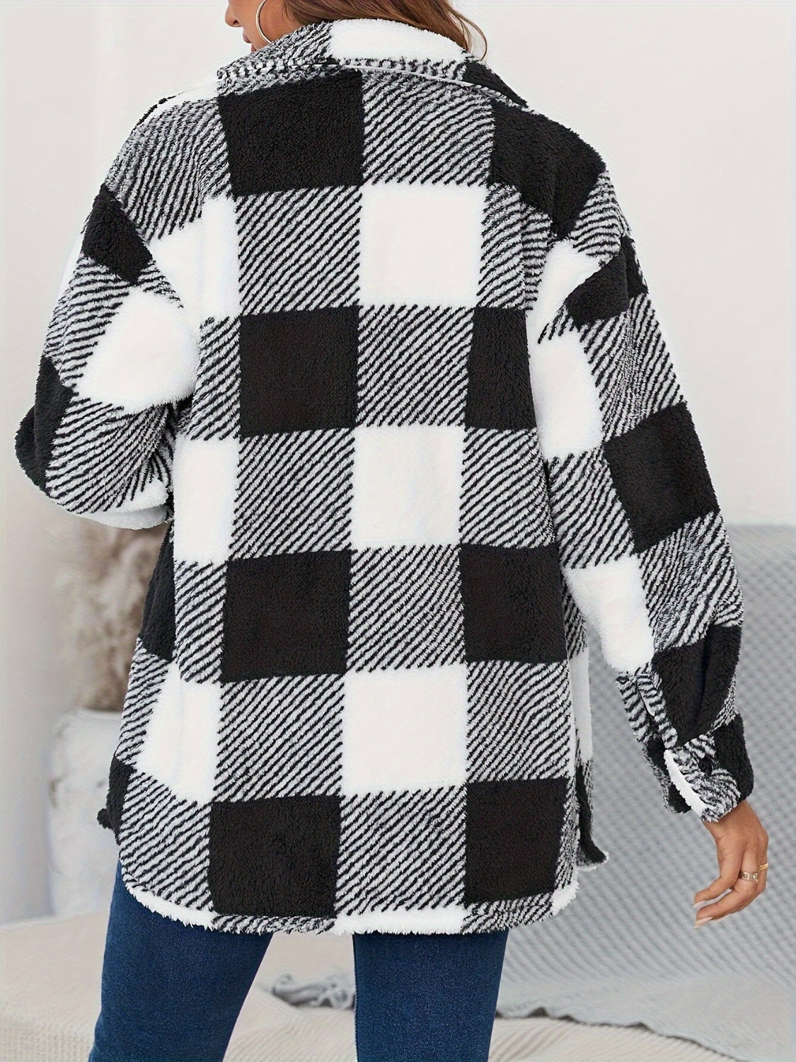Oversized black and white checkerboard sherpa shacket with button-down front and fuzzy texture.