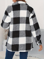 Oversized black and white checkerboard sherpa shacket with button-down front and fuzzy texture.