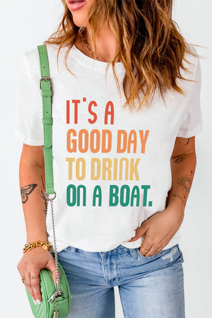 White graphic t-shirt with colorful text that says "IT'S A GOOD DAY TO DRINK ON A BOAT.