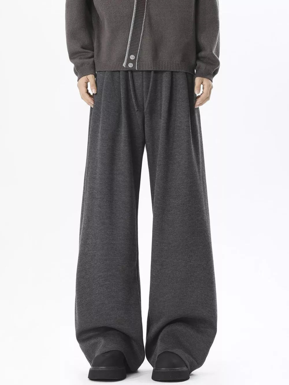 Gray wide-leg sweatpants with adjustable drawstring waist, styled casually.