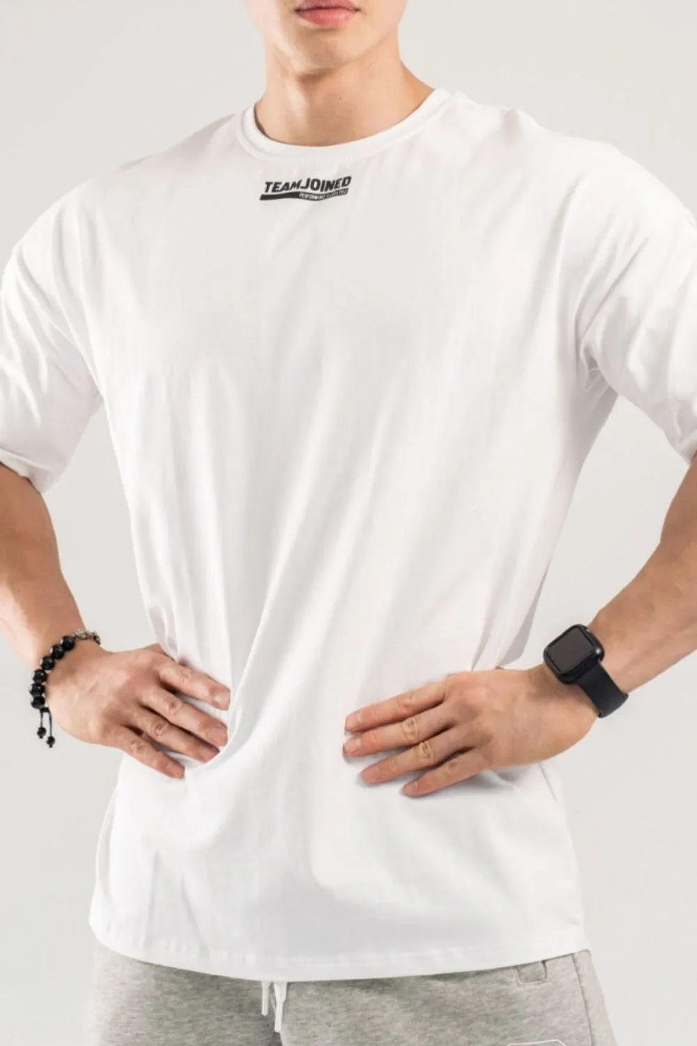 White oversized t-shirt with black logo detail on the chest.