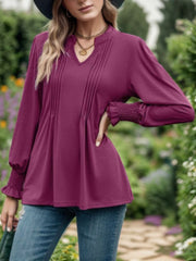 Deep purple blouse with pleated yoke, V-neck, and gathered cuffs.