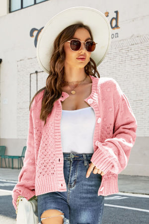 Pink acrylic cropped cardigan with bubble sleeves and textured detail
