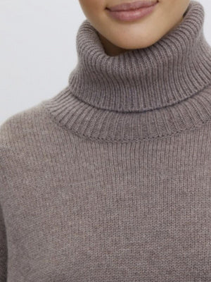Turtleneck sweater in Dust Storm acrylic knit with ribbed collar and neckline detail.