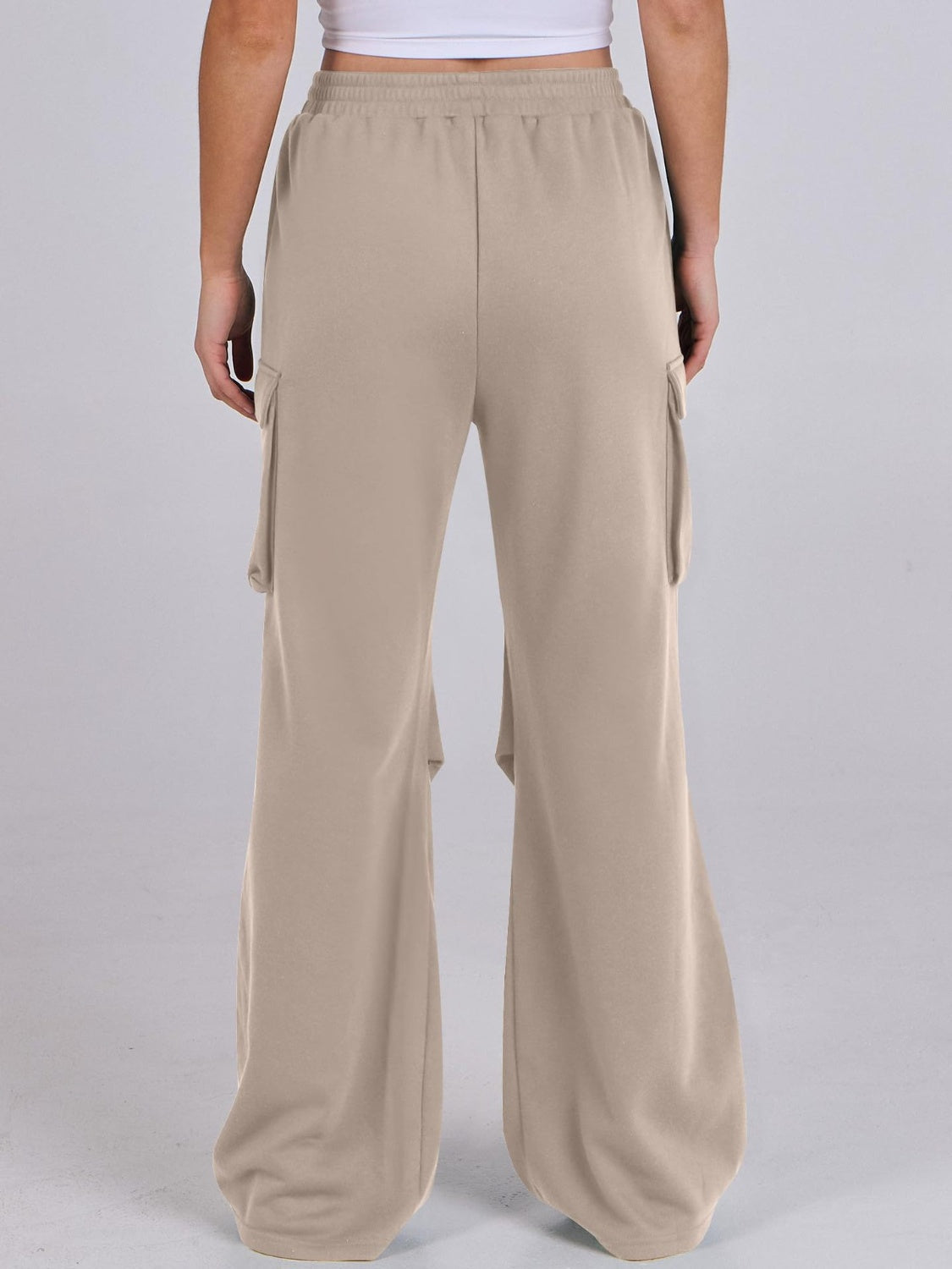 Tan sweatpants with cargo pockets and a wide leg silhouette.