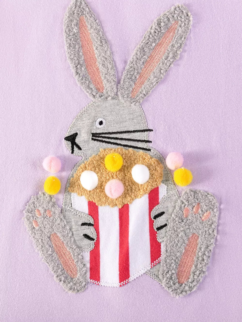 Baby dress with playful bunny appliqué holding popcorn, cotton fabric.