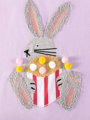 Baby dress with playful bunny appliqué holding popcorn, cotton fabric.