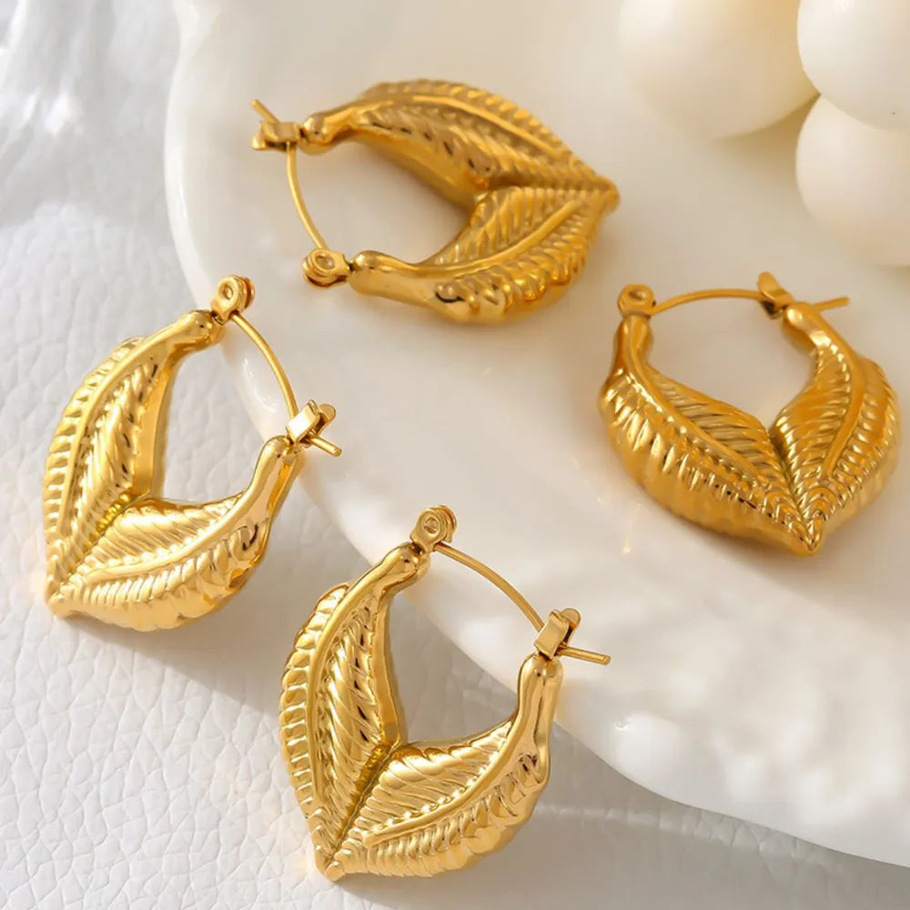 Gold leaf hoop earrings with textured detail, 18K gold-plated.