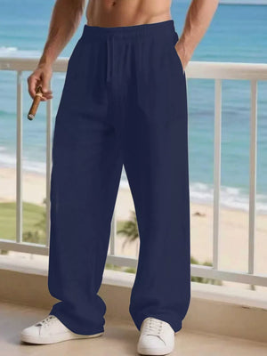 Navy blue linen joggers for men with drawstring and pockets, styled casually.