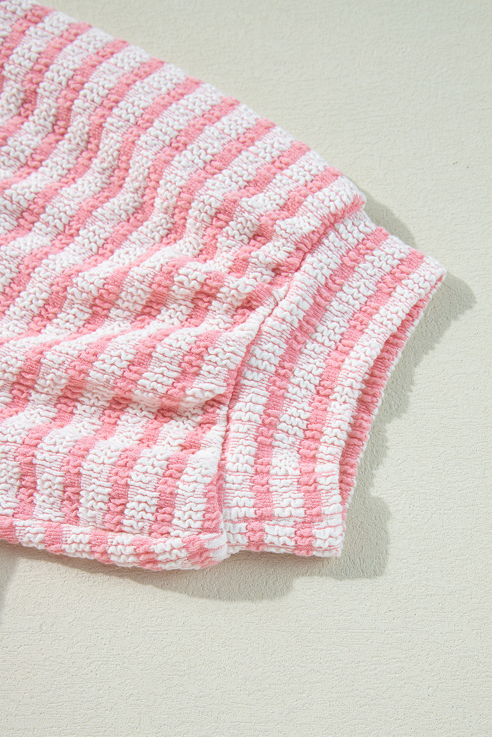 Textured stripe puff sleeve top in blush pink with a seersucker fabric detail.