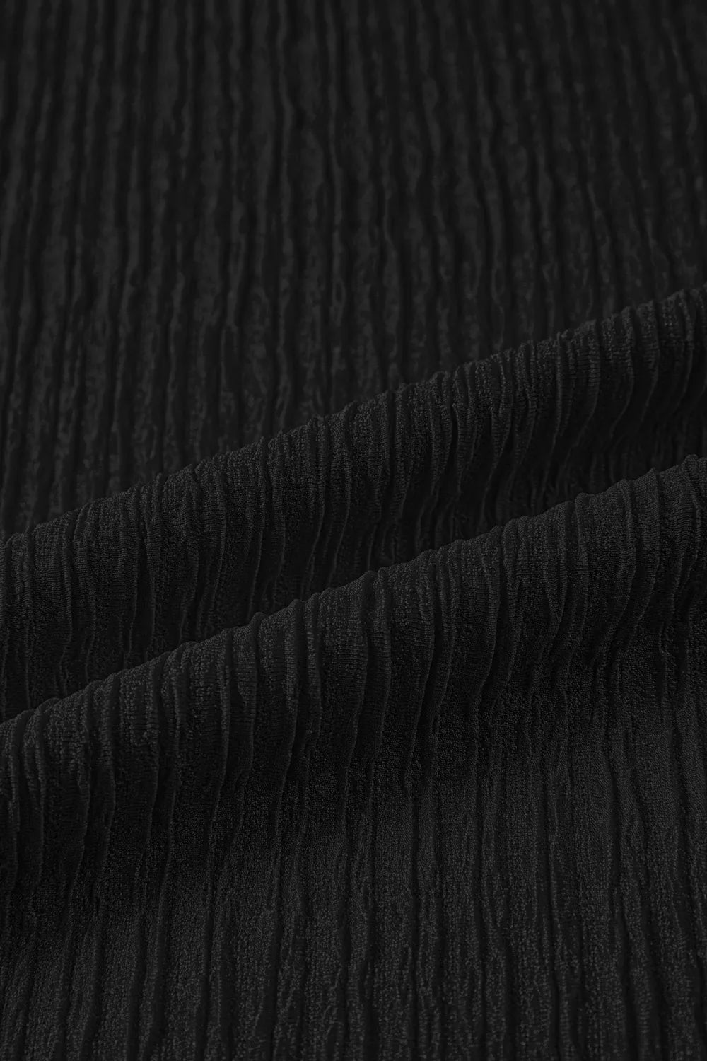 Black textured polyester maternity shirt fabric detail