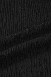 Black textured polyester maternity shirt fabric detail