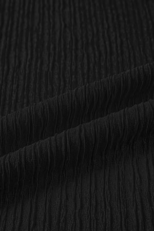 Black textured polyester maternity shirt fabric detail