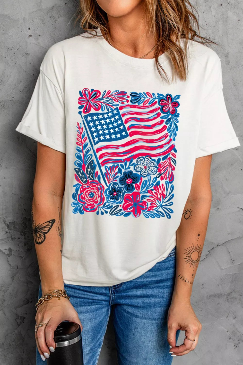 White polyester t-shirt with American flag and floral graphic, crew neck, short sleeves.