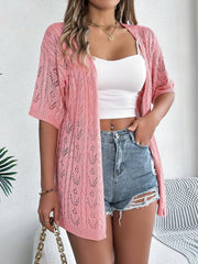 Pink open-knit pointelle cardigan with short sleeves and a relaxed fit.
