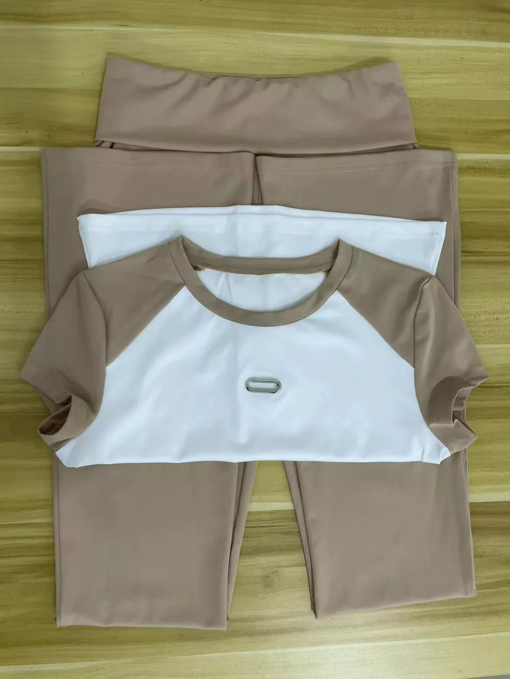 Chic contrast tee and pants set in camel and white with a metal detail on the tee.