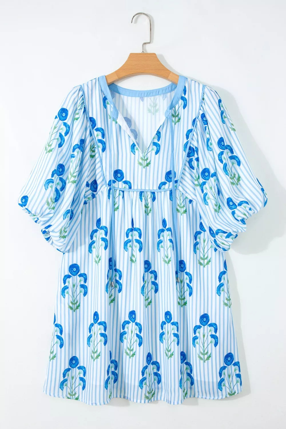 Floral stripe puff sleeve mini dress with blue floral print and tie neck.
