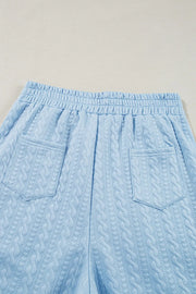 Light blue cable knit lounge shorts with elastic waist and two back pockets.