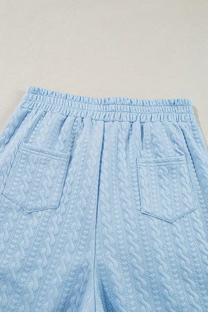 Light blue cable knit lounge shorts with elastic waist and two back pockets.